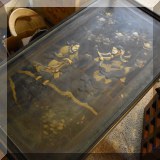 F119. Table with Asian relief top.